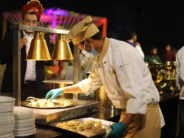 Chef serving guests at a catered banquet event